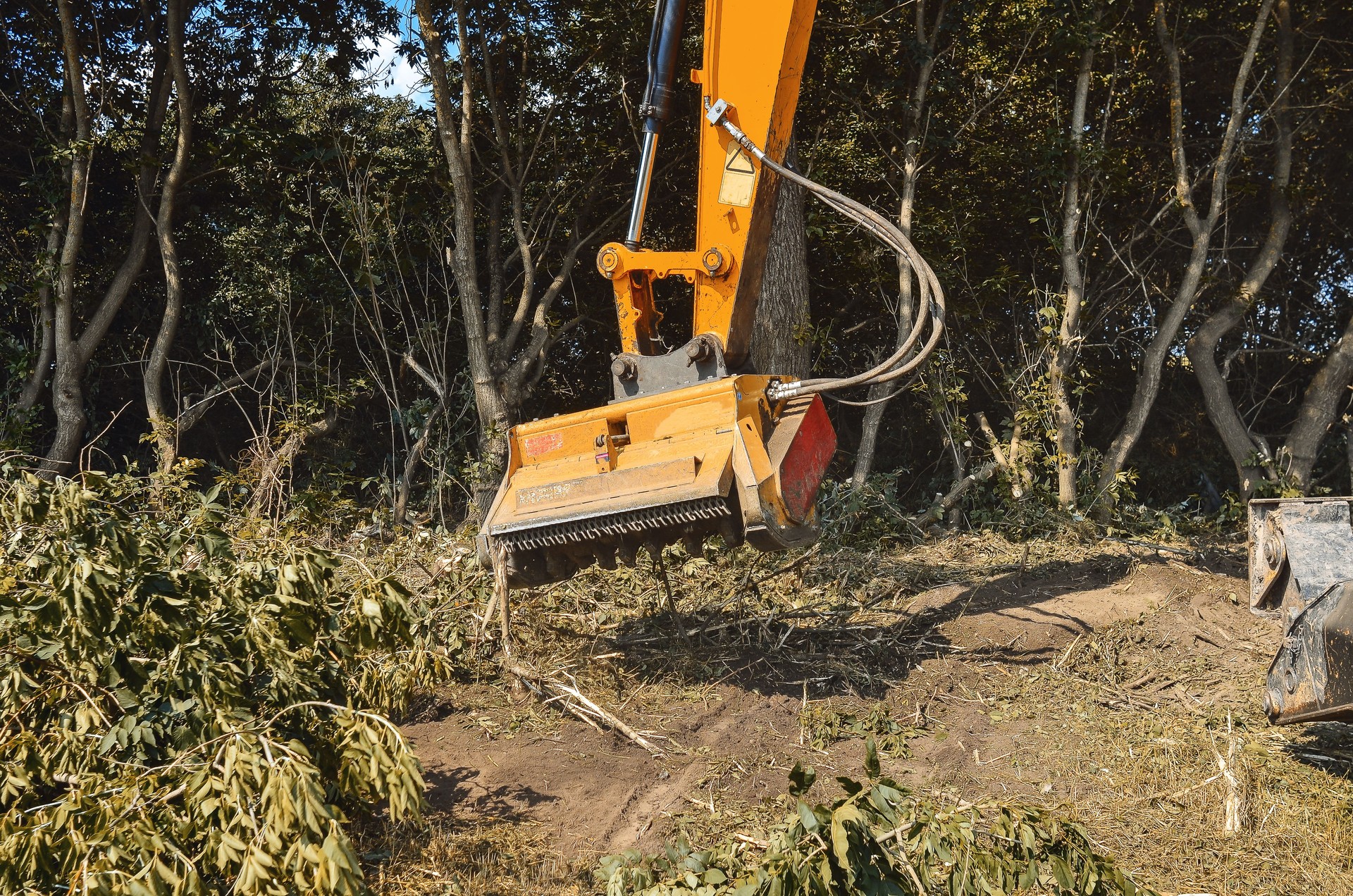 Improving the environment. Mulcher. Processing of branches and weeds.